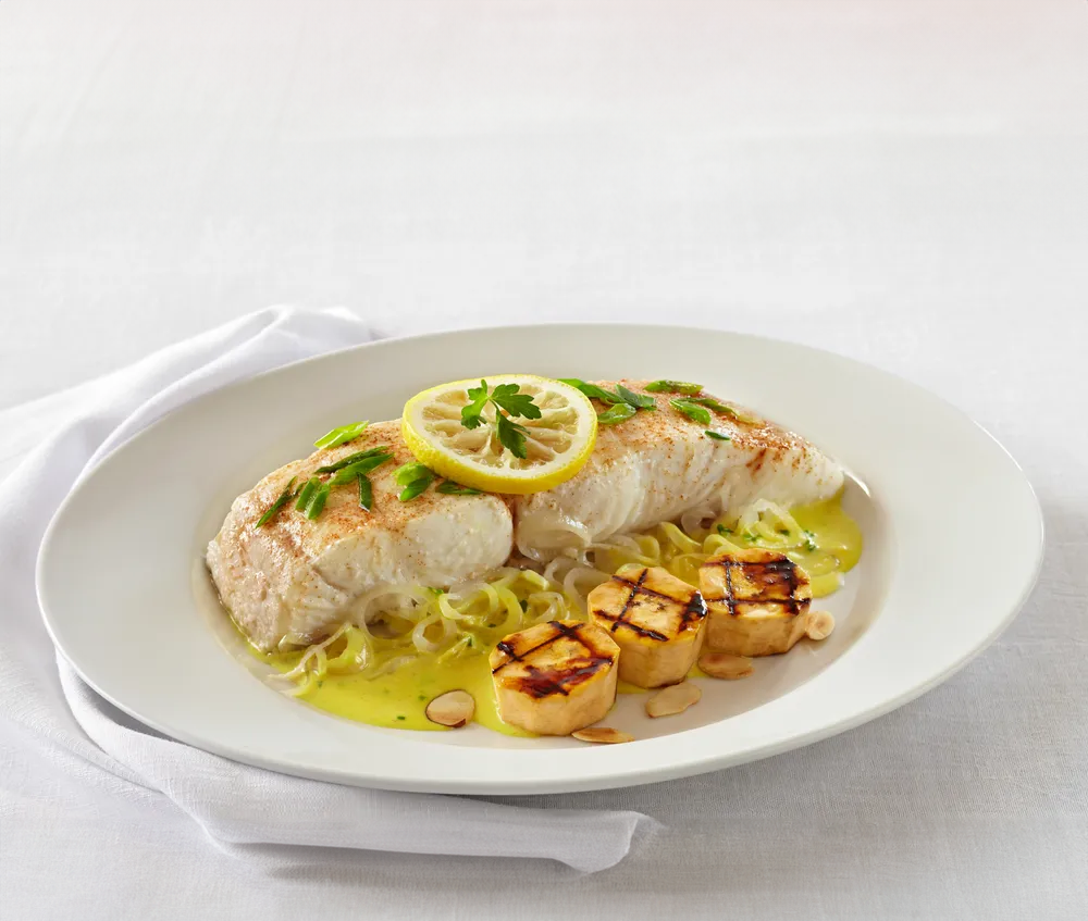 A native tropical fish, the black grouper can be found near Caribbean coral reefs. Flambéed grilled plantains sweetened with brown sugar make a delicious Caribbean accompaniment.