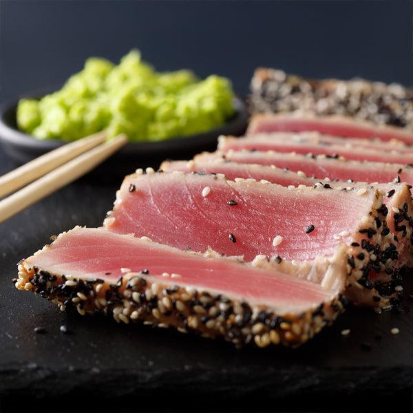 Seared tuna slices with sesame crust, served with wasabi and chopsticks, fresh seafood meal