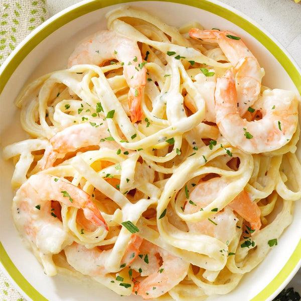 Creamy shrimp fettuccine pasta with fresh herbs, fresh seafood meal