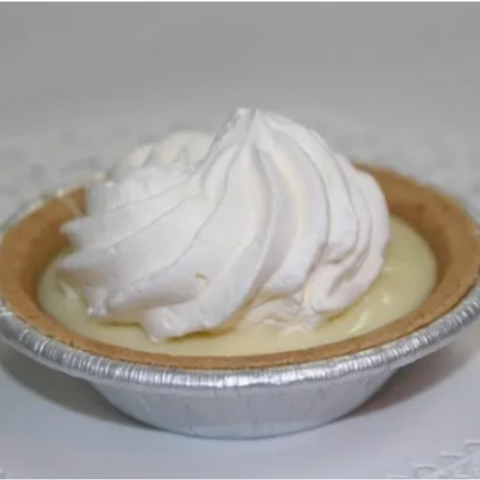 Small pie with whipped cream on a gray background